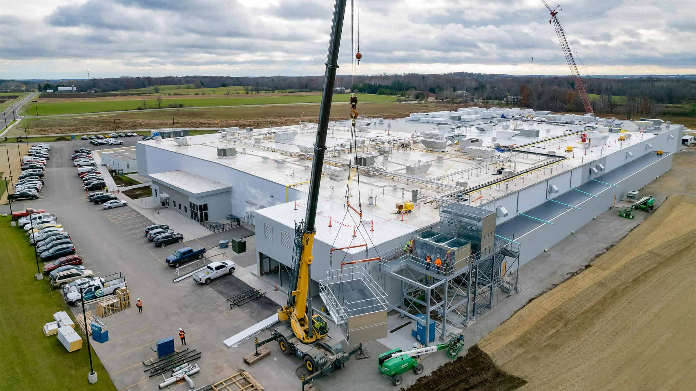 Equipment Installation by Two Cranes during Food and Beverage Facility Construction