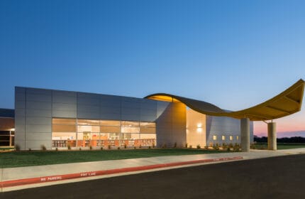 Broken Arrow Public Schools - Highland Park Elementary School Exterior on Site with Drive Lit at Night